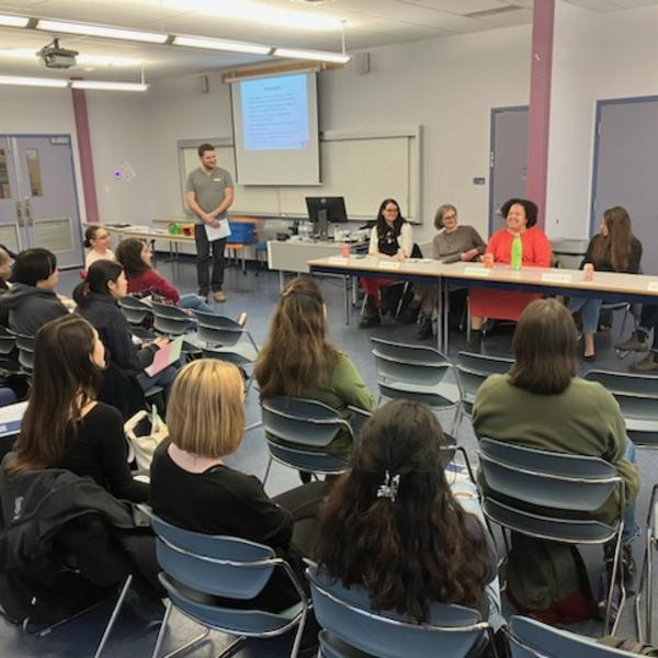 A group of students facing a panel of employers