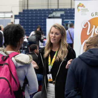 students engaging with employer at career fair